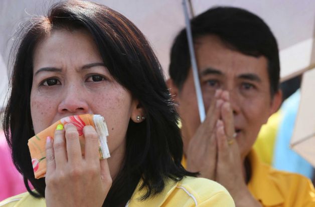  	Một người phụ nữ Thái chú ý lắng nghe lời phát biểu của nhà vua Thái Lan Bhumibol Adulyadej nhân dịp sinh nhật lần thứ 85.